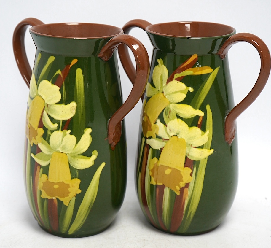 A pair of Watcombe Torquay vases decorated with daffodils, 20cm high. Condition - good